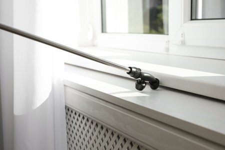 Spraying pesticide on window sill indoors. Pest control serviceの写真素材