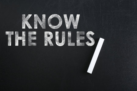 Phrase Know the rules and piece of chalk on blackboard, top viewの写真素材
