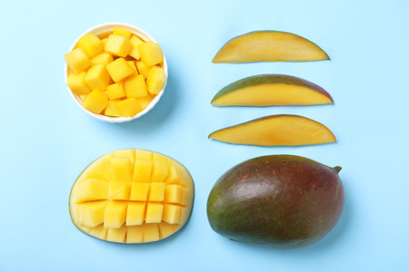 Flat lay composition with fresh ripe mango on light blue backgroundの写真素材