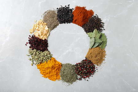 Frame made with different spices on marble background, flat lay. Space for textの写真素材