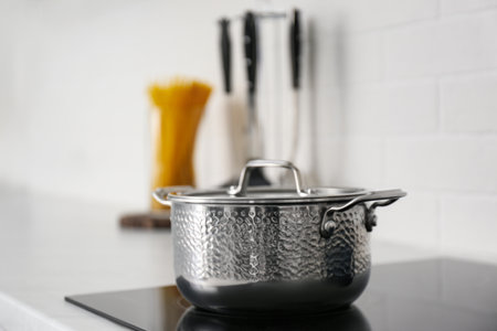 New saucepot on induction stove in kitchenの写真素材