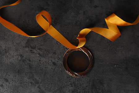 Bronze medal on gray stone background, top view. space for designの写真素材