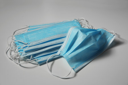 Disposable face masks on light background.
