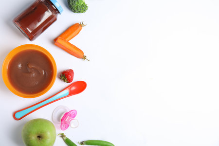 Flat lay composition with healthy baby food and ingredients on white background. Space for textの写真素材