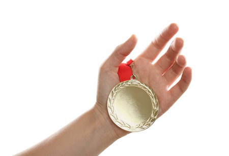 Woman holding gold medal on white background, closeup. space for designの写真素材