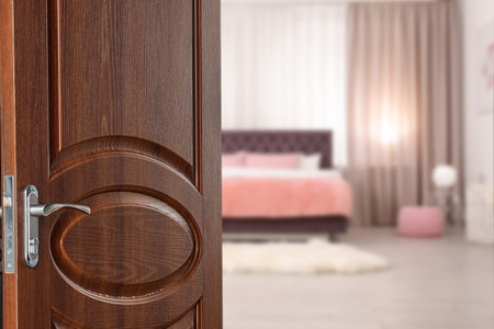 Wooden door open into modern hotel room, closeupの写真素材