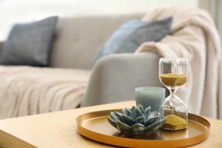 Table with decor near sofa indoors. interior design