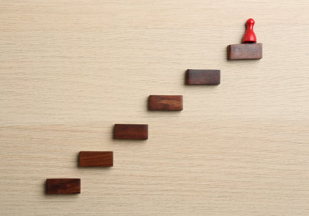 Red piece on top of stairs, flat lay. career promotion concept