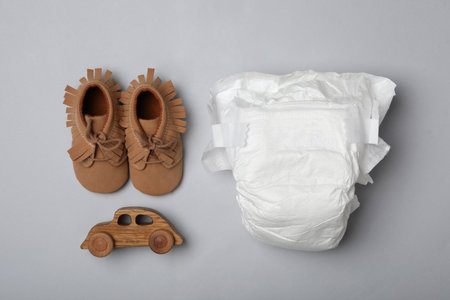 Diaper and baby accessories on light gray background, flat layの写真素材
