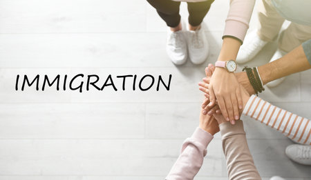 Immigration concept. People holding hands together, top viewの写真素材
