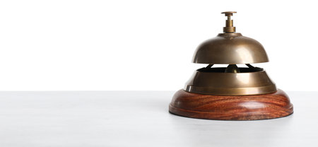 Hotel service bell on wooden table against white backgroundの写真素材