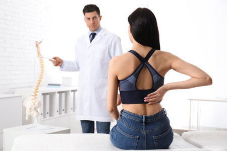 Young woman visiting orthopedist in medical office