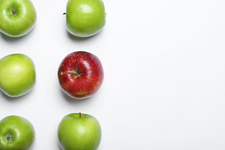 Red apple among green ones on white background, top viewの写真素材