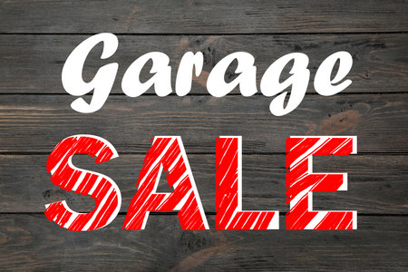 Phrase GARAGE SALE written on wooden surface