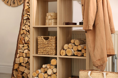 Shelving unit with firewood indoors. interior design