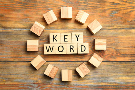 Cubes with word KEYWORD on wooden background, flat layの写真素材