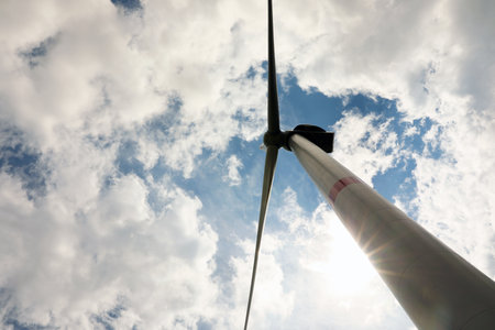 Modern wind turbine against cloudy sky, low angle view. alternative energy sources