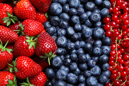 Mix of different ripe tasty berries as background, top viewの写真素材
