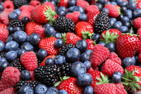 Mix of different ripe tasty berries as background, closeup viewの写真素材