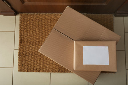 Parcels on rug near door, flat lay. delivery service