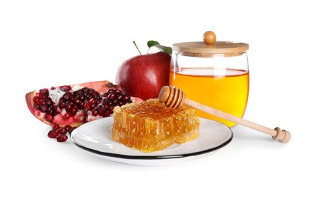 Honey, apple and pomegranate seeds on white background. Rosh Hashanah holidayの写真素材