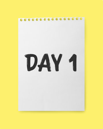 New life chapter beginning. Notebook paper with text Day 1 on yellow background, top view