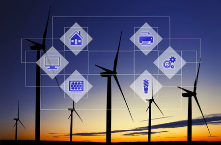 alternative energy sources. Silhouettes of wind turbines at sunset and schemeの写真素材