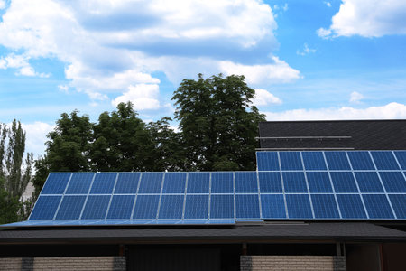 Building with installed solar panels on the roof. alternative energy sources