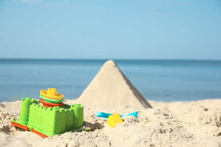 Different child plastic toys on sandy beachの写真素材