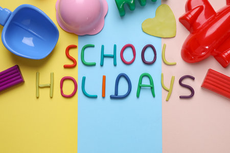 Flat lay composition with phrase School Holidays made of modeling clay on color backgroundの写真素材