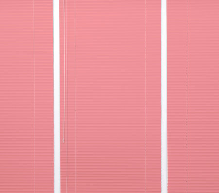 Window with closed coral horizontal blinds as backgroundの写真素材