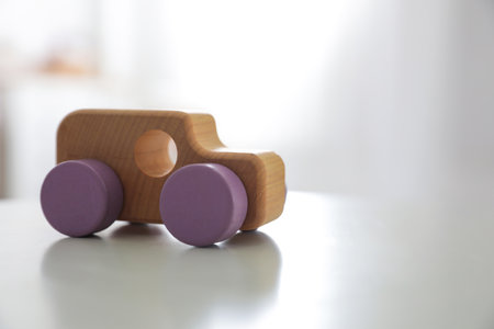 Wooden car on white table indoors. Space for textの写真素材