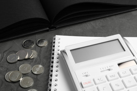 Calculator, notebook and money on dark gray table, closeup. tax accountingの写真素材