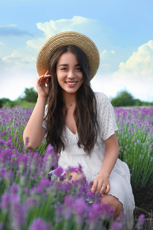 Young woman in lavender field on summer dayの写真素材