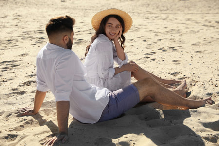 Happy young couple on sandy beach. Honeymoon tripの写真素材