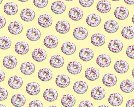Creative pattern design of glazed donuts on pale yellow backgroundの写真素材