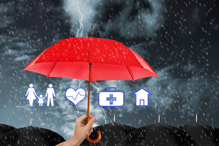 Insurance agent covering illustrations with red umbrella during stormの写真素材
