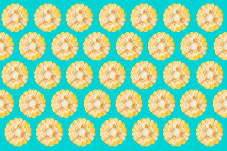 Pattern of corn cob pieces on turquoise background