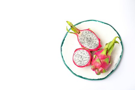 Delicious cut and whole dragon fruits (pitahaya) on white background, top viewの写真素材