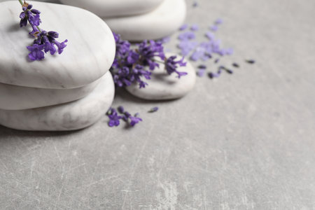 Stones, sea salt and lavender flowers on gray table, closeup. Space for textの写真素材