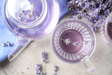 Fresh delicious drink with lavender in glass cup on gray table, flat layの写真素材