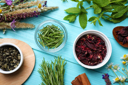 Flat lay composition with healing herbs on light blue wooden table