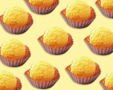 Tasty candies on pale yellow background. pattern designの写真素材