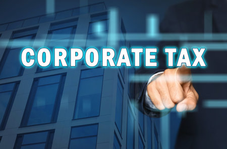 corporate tax concept. Double exposure of man touching virtual screen and modern office building, closeupの写真素材