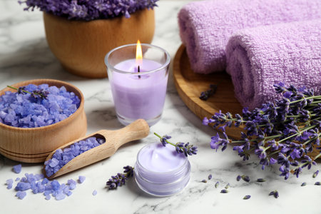 Cosmetic products and lavender flowers on white marble tableの写真素材