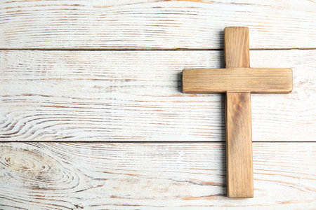 Christian cross on white wooden background, top view with space for text. religion conceptの写真素材
