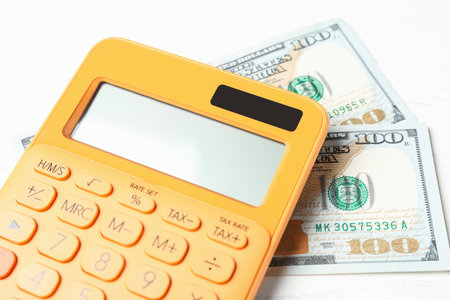 Calculator and money on white wooden table, closeup. tax accountingの写真素材