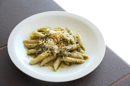 Delicious penne pasta with pesto sauce on plateの写真素材