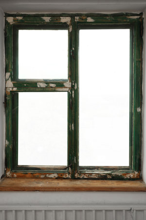 Old window with empty wooden sill in room