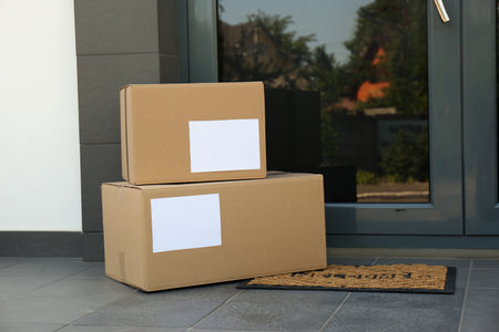 Cardboard boxes near door. Parcel delivery service